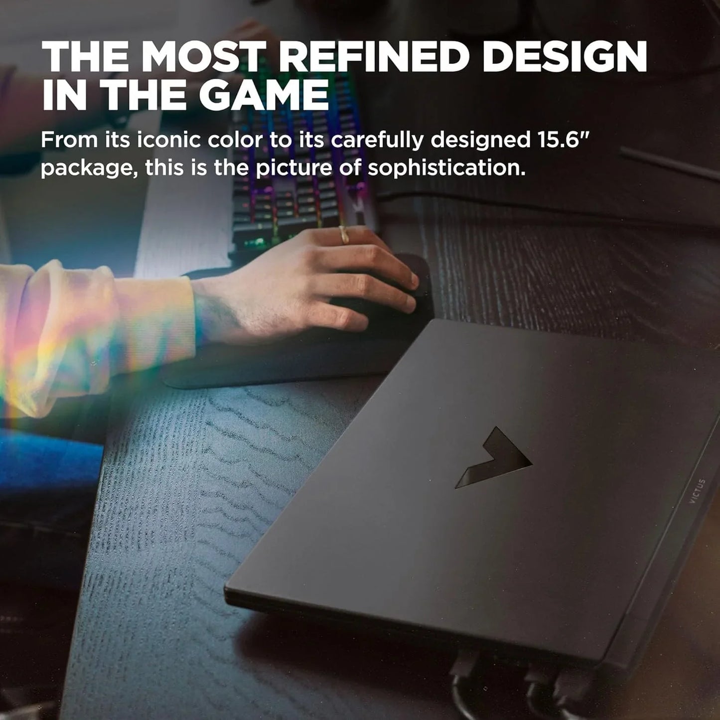TechNest Victus 15.6 inch gaming laptop closed on desk with hand using keyboard in background